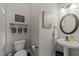 Charming powder room with decorative wall art, pedestal sink, and stylish fixtures at 7520 Channery Way, Raleigh, NC 27616