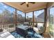 Cozy screened porch with comfortable seating, a ceiling fan, and backyard views at 7520 Channery Way, Raleigh, NC 27616