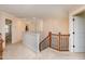 Bright hallway features a staircase, neutral walls and carpet, with views to bedrooms at 805 Clausun Dr, Durham, NC 27713