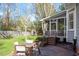 Backyard featuring wood deck, table, chairs and green grass at 8617 Canoe Ct, Raleigh, NC 27615