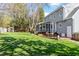 View of the home's backyard with a deck and furniture, as well as a storage shed at 8617 Canoe Ct, Raleigh, NC 27615
