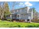 View of the home's backyard, which includes a deck with outdoor furniture and a screened in porch at 8617 Canoe Ct, Raleigh, NC 27615