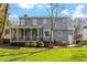Expansive backyard with a screened porch, deck, and lush green lawn, perfect for outdoor entertaining at 8617 Canoe Ct, Raleigh, NC 27615