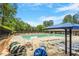 Community pool featuring plenty of seating, a large pool, and a sun shade at 8617 Canoe Ct, Raleigh, NC 27615