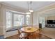Dining room features hardwood floors, pendant lights, and large bay window with window seat at 8617 Canoe Ct, Raleigh, NC 27615