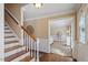 Foyer features hardwood floors, crown molding, staircase, and view into the living room at 8617 Canoe Ct, Raleigh, NC 27615