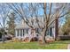 Attractive home with a red front door, gray siding, and a well-kept lawn and mature trees at 8617 Canoe Ct, Raleigh, NC 27615