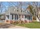 Lovely home with a red front door, dormer windows, and a well-maintained lawn and landscaping at 8617 Canoe Ct, Raleigh, NC 27615