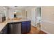 Eat-in kitchen featuring stainless steel appliances, custom blue cabinets, and hardwood floors at 8617 Canoe Ct, Raleigh, NC 27615