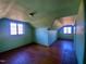 This is a picture of the attic bedroom with wood floors and 2 windows at 1006 Stallings Rd, Durham, NC 27703