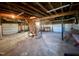 Spacious unfinished basement with exposed ceiling, concrete floor, and stairs leading to the upper level at 1006 Stallings Rd, Durham, NC 27703