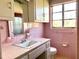 This is a picture of the bathroom with pink tile and a window at 1006 Stallings Rd, Durham, NC 27703