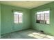 This is a picture of a bedroom with light green walls and two windows at 1006 Stallings Rd, Durham, NC 27703