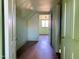 This is a picture of the hallway with wood floors and 3 doors at 1006 Stallings Rd, Durham, NC 27703