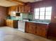 Charming kitchen featuring wooden cabinets, a window, and laminate countertops for a retro vibe at 1006 Stallings Rd, Durham, NC 27703