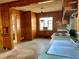 Cozy kitchen with wood paneling, vintage cabinets, and a bright window providing natural light at 1006 Stallings Rd, Durham, NC 27703