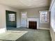 Cozy living room featuring a fireplace, windows, and green carpet, perfect for relaxing at 1006 Stallings Rd, Durham, NC 27703