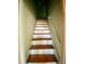 This is a picture of a staircase with wooden steps and handrail at 1006 Stallings Rd, Durham, NC 27703