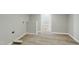 Clean and spacious unfinished basement area with new flooring and an open doorway at 1013 Traders Trl, Wake Forest, NC 27587