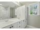Bright bathroom featuring a double sink vanity, storage, and a window with natural light at 1013 Traders Trl, Wake Forest, NC 27587