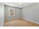 Bright bedroom featuring wood floors and a window offering natural light in a neutral space at 1013 Traders Trl, Wake Forest, NC 27587