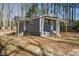 Charming home with gray siding and natural wood accents, surrounded by trees at 1013 Traders Trl, Wake Forest, NC 27587