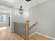 Hallway featuring wrought iron banister and view to window at 1013 Traders Trl, Wake Forest, NC 27587