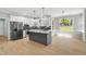 Modern kitchen with white cabinets, gray island, stainless steel appliances, and hardwood floors at 1013 Traders Trl, Wake Forest, NC 27587