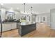Bright kitchen features granite countertops, stainless appliances, and large windows at 1013 Traders Trl, Wake Forest, NC 27587
