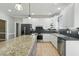 Kitchen features granite island, stainless appliances, and custom white cabinetry at 1013 Traders Trl, Wake Forest, NC 27587
