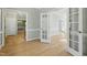 Open-concept living area with hardwood floors and white trim, showcasing ample space and natural light at 1013 Traders Trl, Wake Forest, NC 27587