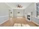 Open living room featuring hardwood floors, a fireplace, and multiple windows offering natural light at 1013 Traders Trl, Wake Forest, NC 27587