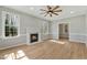Bright living room with a fireplace, large windows, hardwood floors and neutral paint at 1013 Traders Trl, Wake Forest, NC 27587