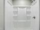 Clean and modern shower with built-in shelves and a sleek chrome fixture at 1013 Traders Trl, Wake Forest, NC 27587