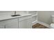 Close-up on a bathroom sink with white cabinets and shelving at 1013 Traders Trl, Wake Forest, NC 27587