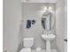 Bathroom featuring a pedestal sink, oval mirror, and a two-piece toilet at 10510 Sablewood Dr # 108, Raleigh, NC 27617