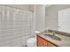 Neutral bathroom with a wood vanity, toilet, and shower with a curtain at 10510 Sablewood Dr # 108, Raleigh, NC 27617