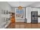 A stylish dining area with modern lighting, and stainless steel refrigerator at 10510 Sablewood Dr # 108, Raleigh, NC 27617