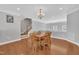 A spacious dining room adjacent to the stairway, features a light fixture and wood flooring at 10510 Sablewood Dr # 108, Raleigh, NC 27617