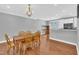 Spacious dining area with hardwood floors and a modern chandelier at 10510 Sablewood Dr # 108, Raleigh, NC 27617