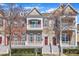 Inviting townhome exterior with multiple levels, a covered porch, and freshly landscaped grounds at 10510 Sablewood Dr # 108, Raleigh, NC 27617