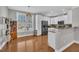 Modern kitchen with stainless steel appliances, white cabinets, and hardwood floors at 10510 Sablewood Dr # 108, Raleigh, NC 27617