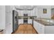 Bright kitchen features stainless steel appliances, granite countertops, and white cabinetry at 10510 Sablewood Dr # 108, Raleigh, NC 27617