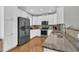 Bright kitchen features stainless steel appliances, granite countertops, and white cabinetry at 10510 Sablewood Dr # 108, Raleigh, NC 27617