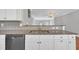 This kitchen features stainless steel appliances, granite countertops, and white cabinetry at 10510 Sablewood Dr # 108, Raleigh, NC 27617