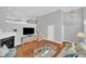 Bright and airy living room featuring a fireplace, hardwood floors, and ample natural light at 10510 Sablewood Dr # 108, Raleigh, NC 27617