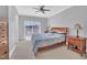 Bright main bedroom features a ceiling fan, balcony, and views of the community at 10510 Sablewood Dr # 108, Raleigh, NC 27617