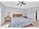 A spacious main bedroom with gray walls, side tables with lamps, and a ceiling fan at 10510 Sablewood Dr # 108, Raleigh, NC 27617