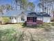 Lovely backyard with a deck and mature trees giving ample shade at 110 Chickasaw Cir, Clayton, NC 27527