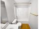 Bright bathroom featuring a shower-tub combo with gold fixtures and wood floor at 110 Chickasaw Cir, Clayton, NC 27527